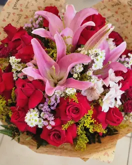 Buquê de rosas vermelhas e lírios rosa montado pela Flores Bellas
